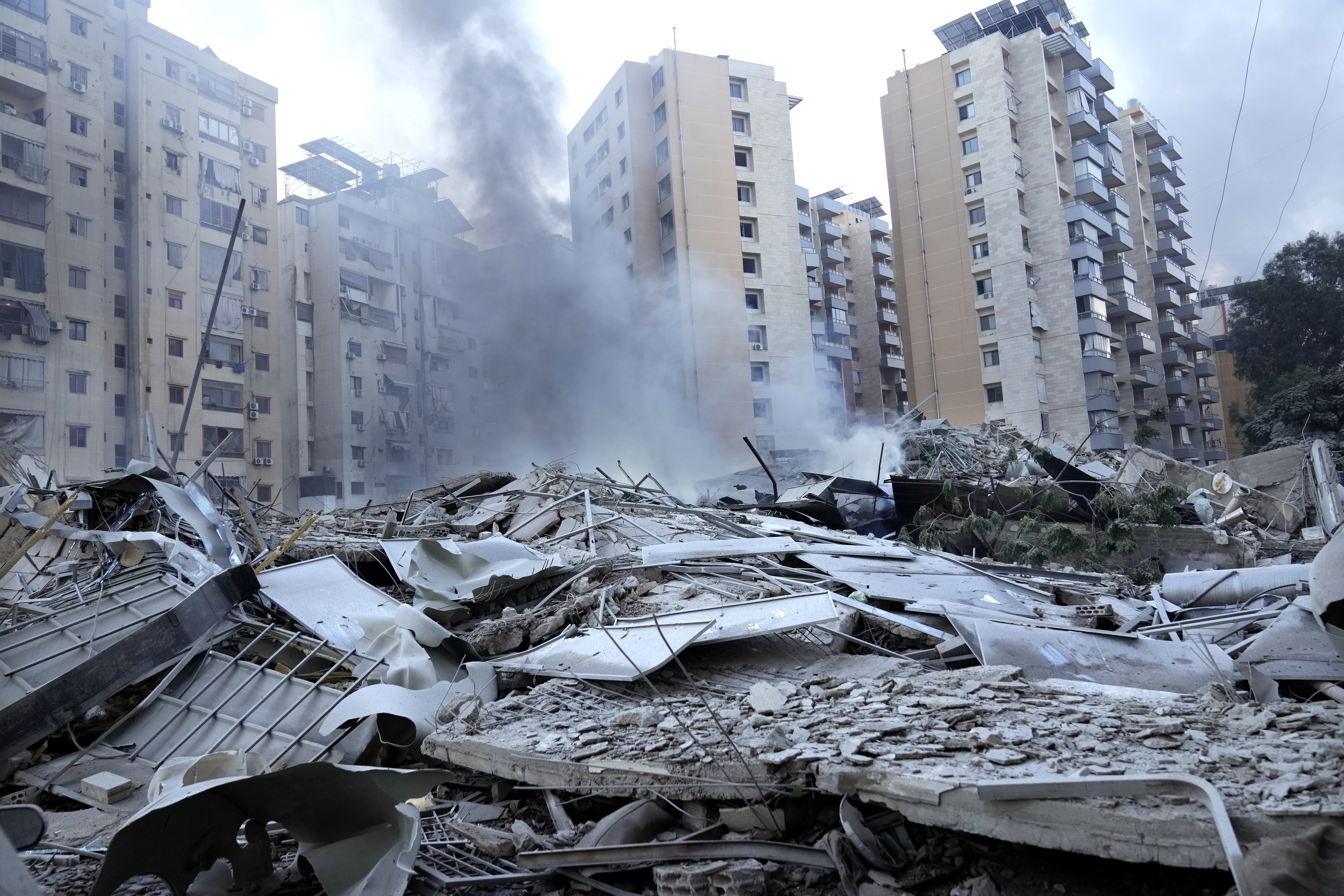 Smoke rises from a destroyed resident complex hit by Israeli airstrikes in Dahieh, Beirut, Lebanon, Wednesday, Oct. 2, 2024. (AP Photo/Hussein Malla)(AP10_02_2024_000192B)